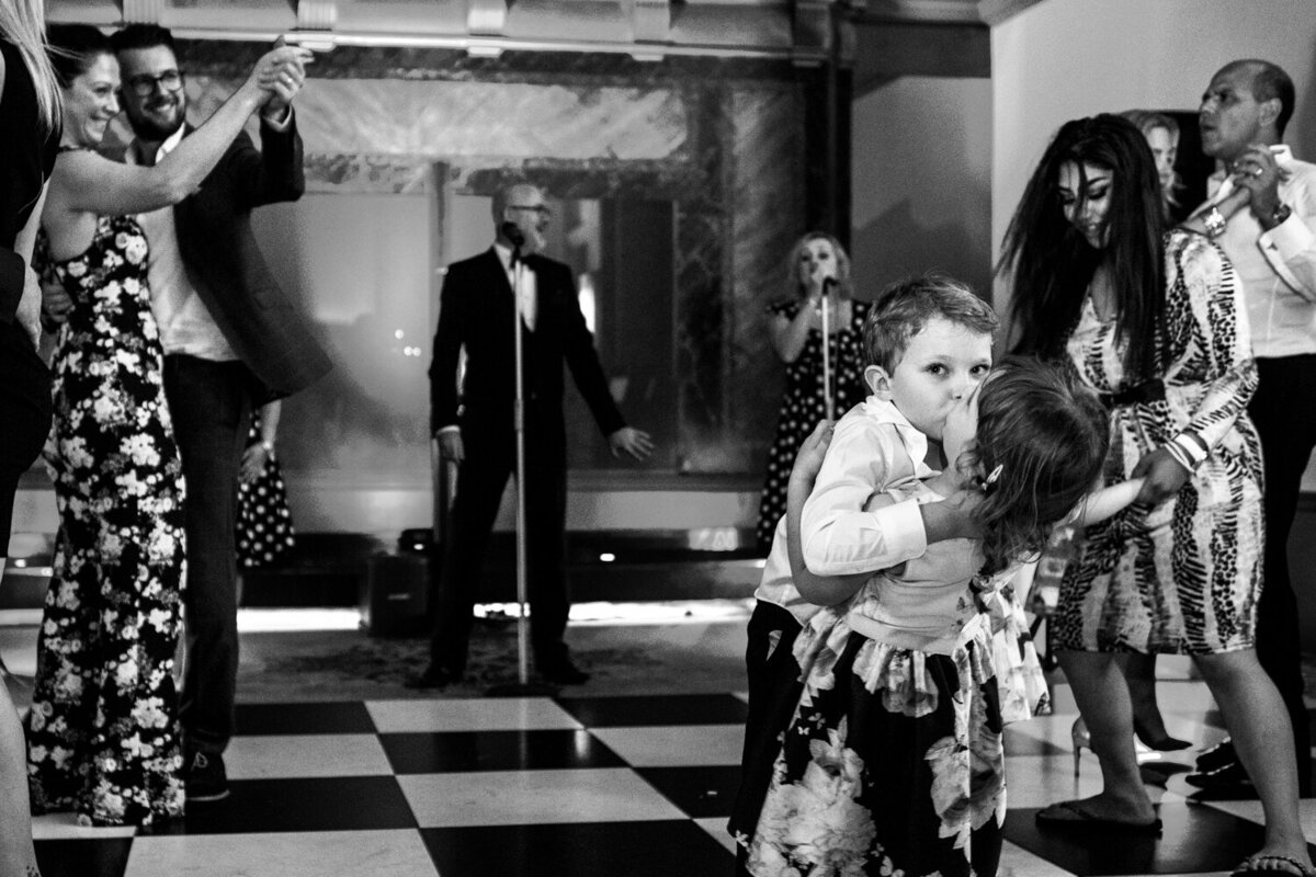 boy kissing little girl on a  dance floor