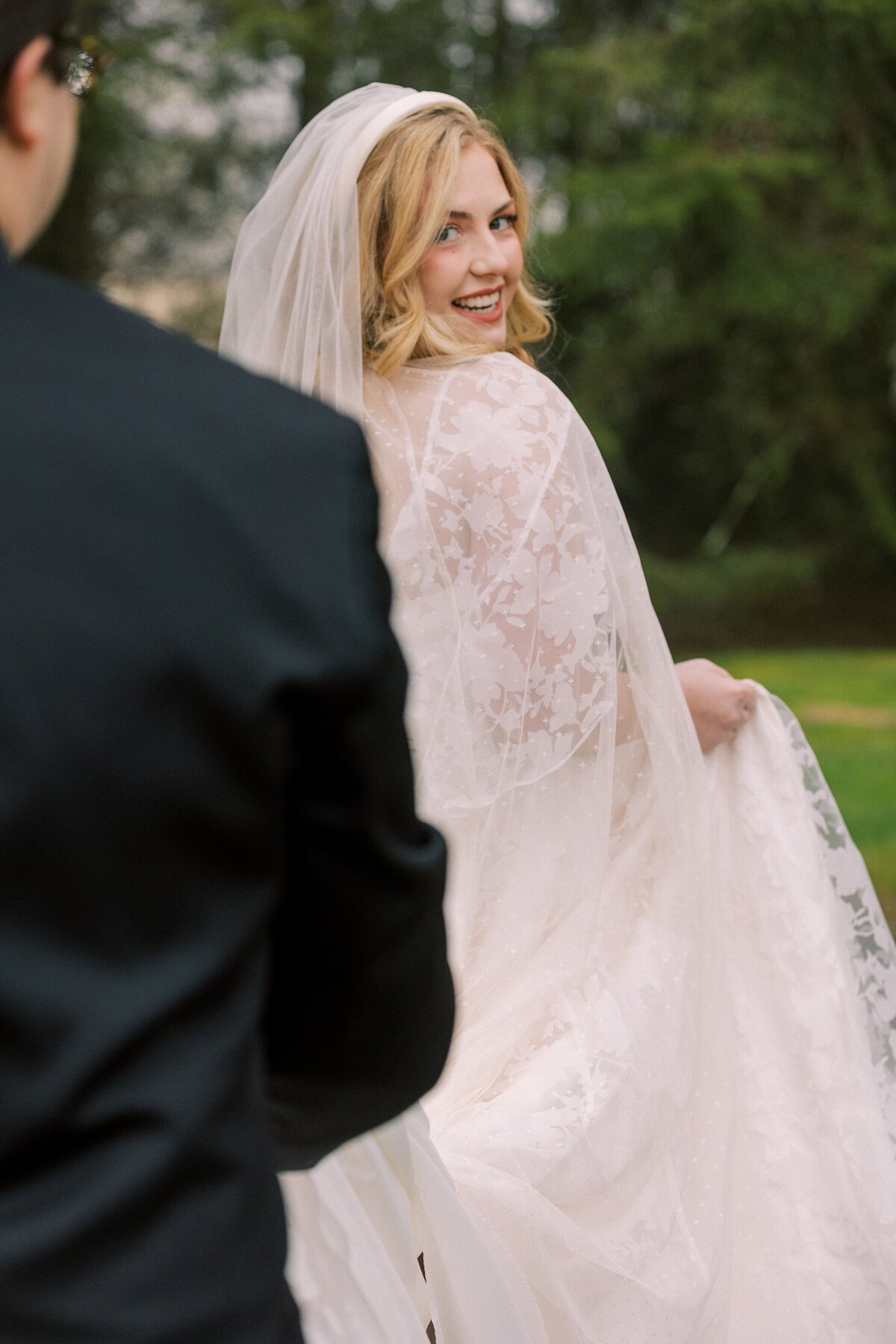 Bride looks over her shoulder as she walks