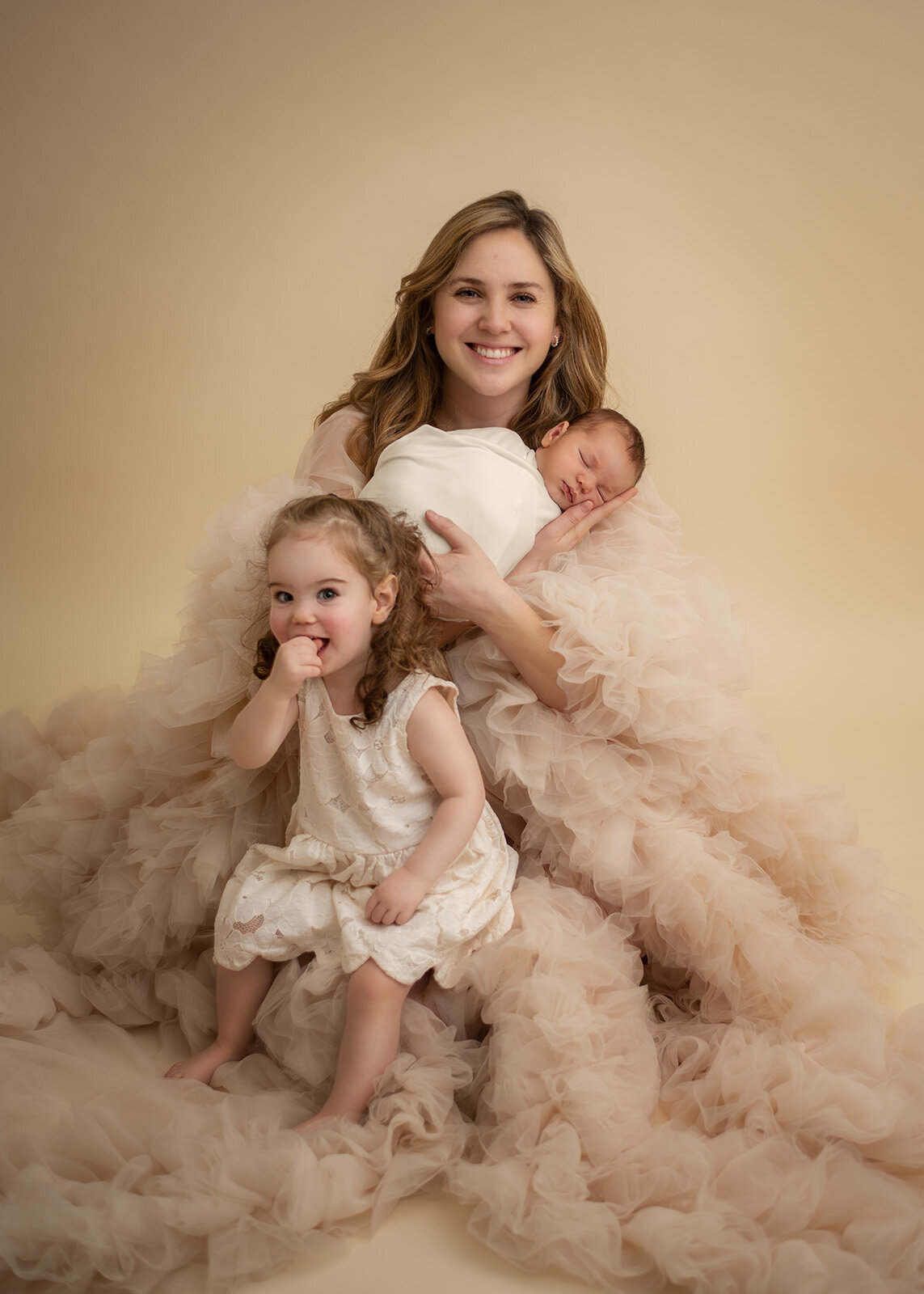 mom and her kids at their newborn photo session