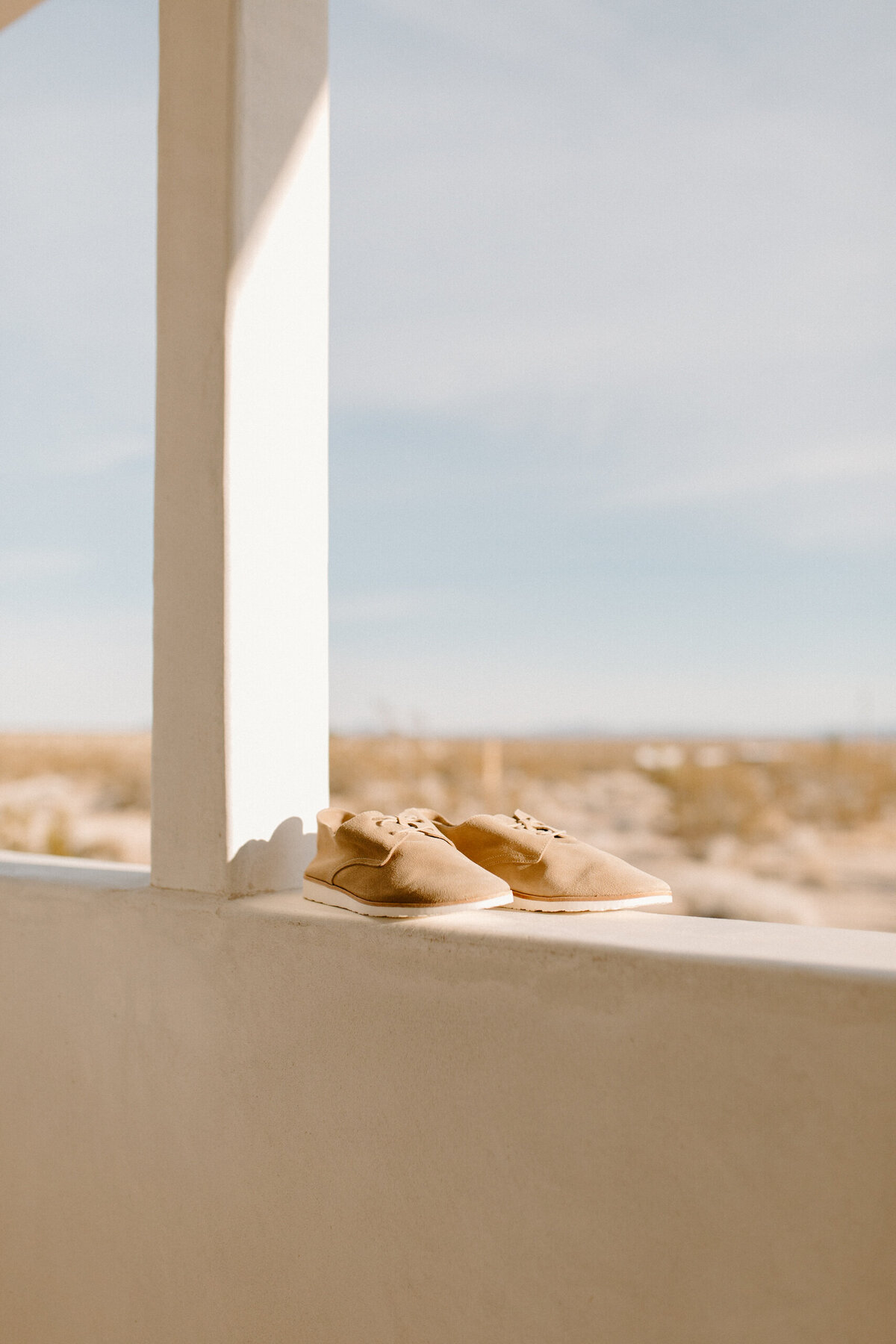 shoes on a ledge in the desert