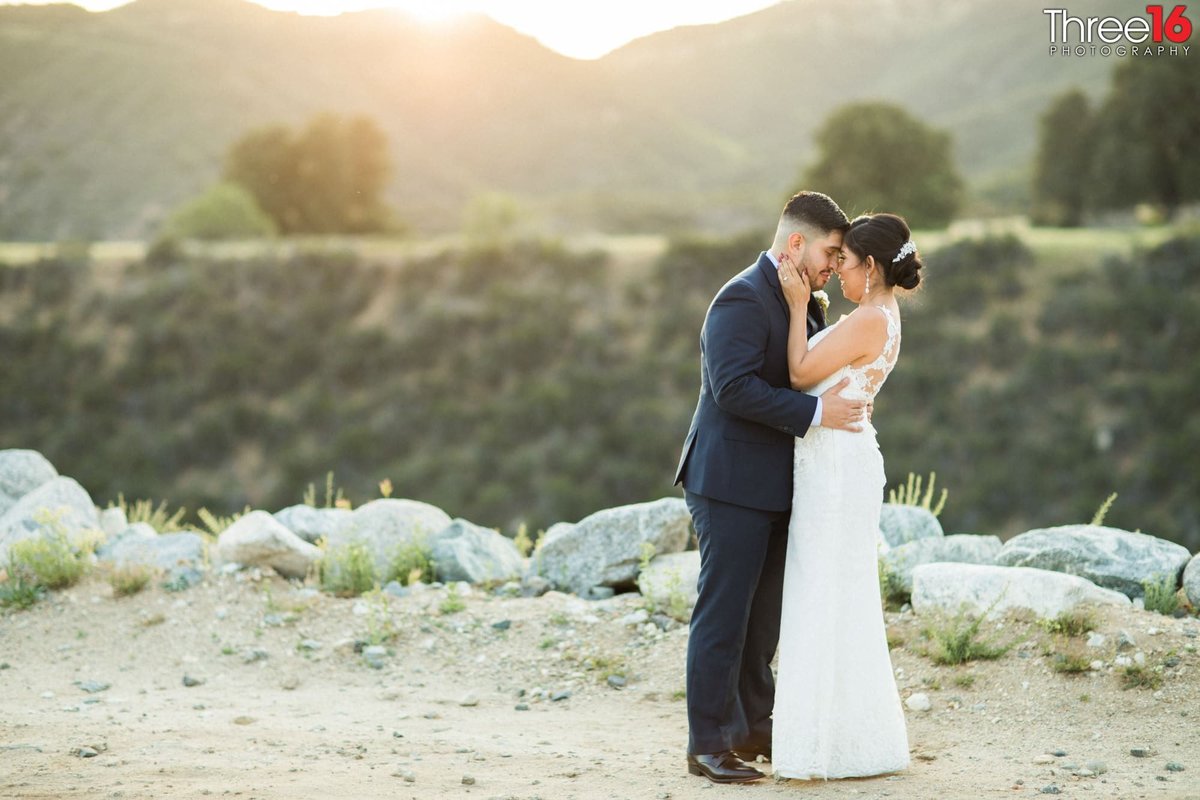 Tender moment for Bride and Groom as they hold each other before sunset in Oak Glen, CA