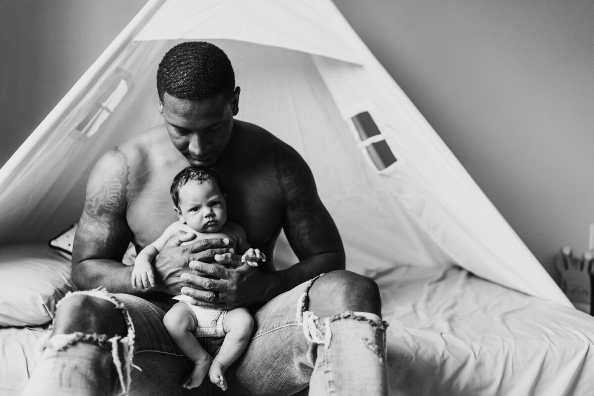 seattle-dad-holding-his-newborn-son-at-home