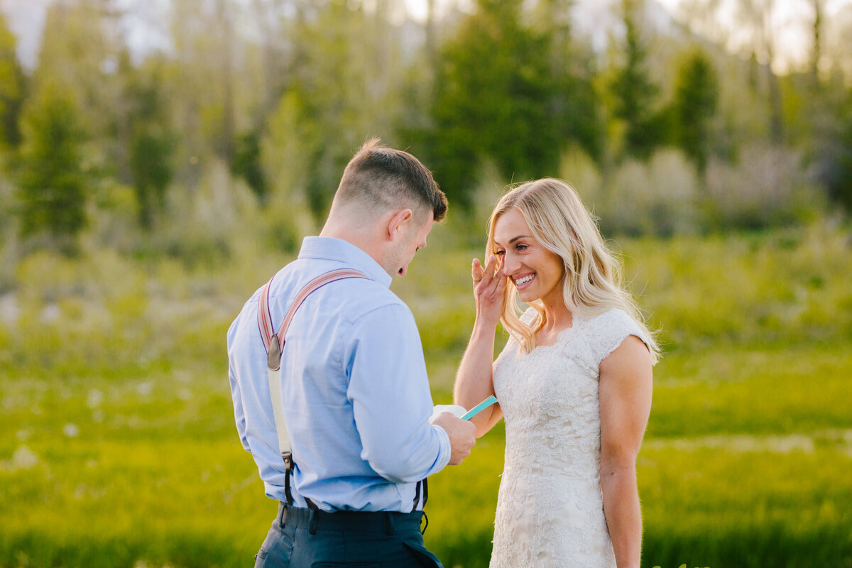 Jackson Hole photographers capture couple reading vows and seeing one another for first time before Grand Teton wedding