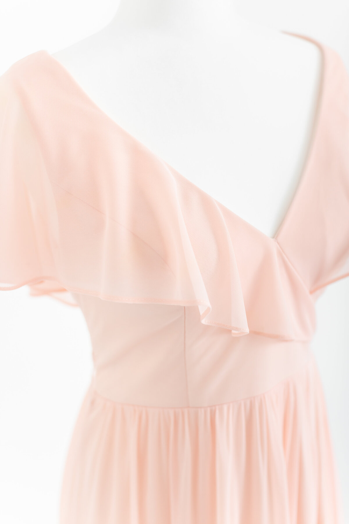 A closeup photo of a peach dress with a v neck and flutter sleeves by Washington DC Family PhotographerWashington DC Family Photographer