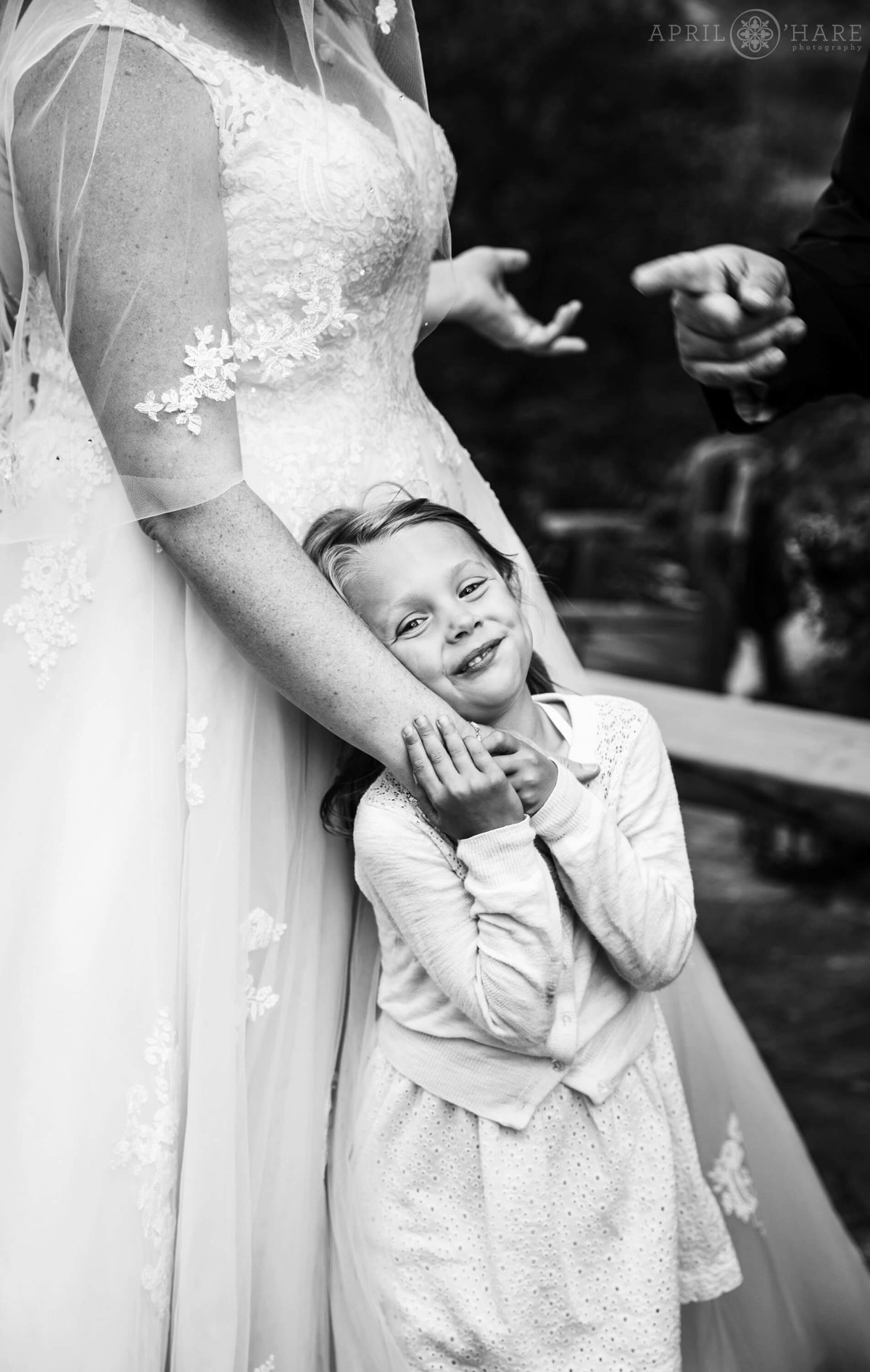 Cute B&W Photo of Flower Girl snuggling Bride at a Colorado Mountain Wedding