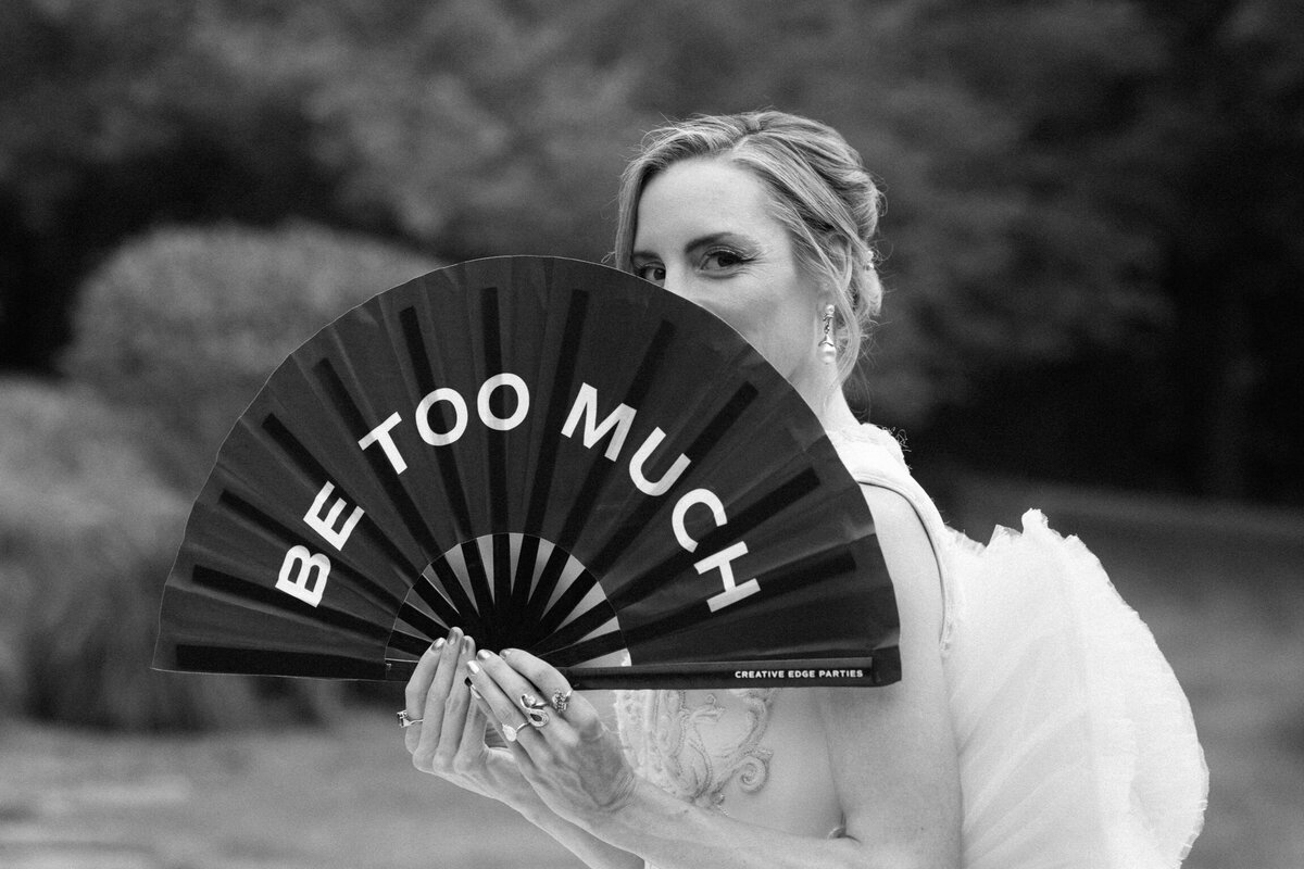 bride with fan on wedding day