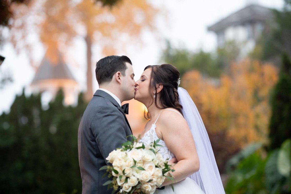 Bride and groom kissing at Fox Hollow