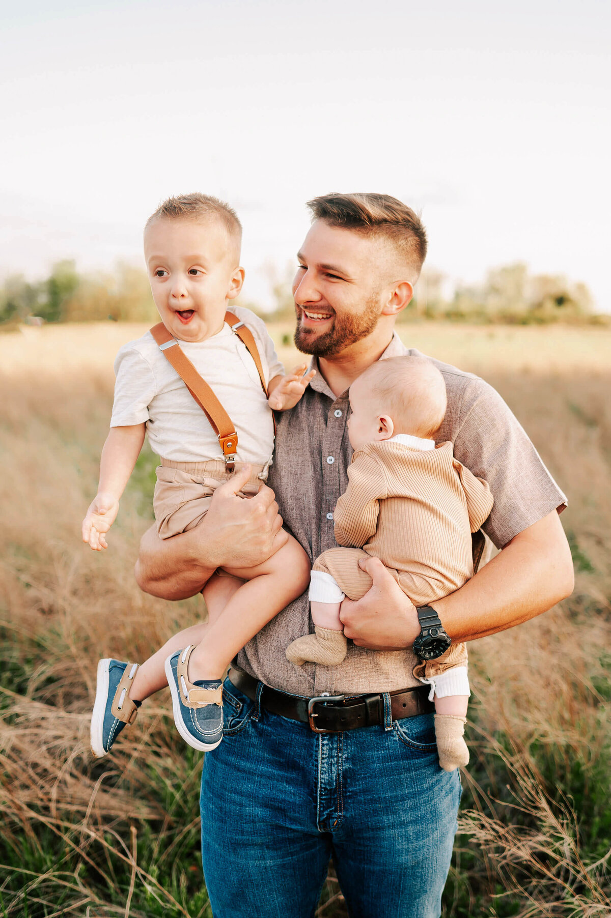 dad holding excited son during Springfield Mo family photography session