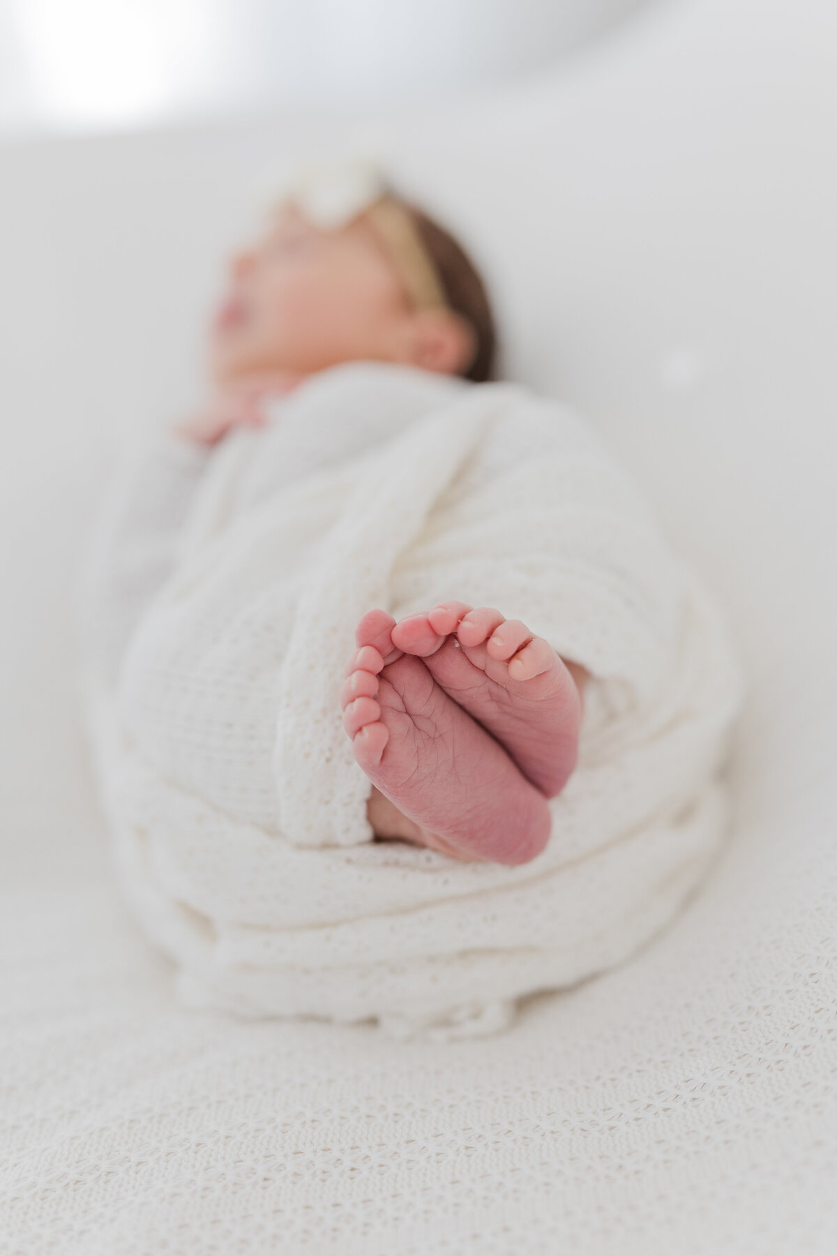 Close up image of newborn baby girls feet together.