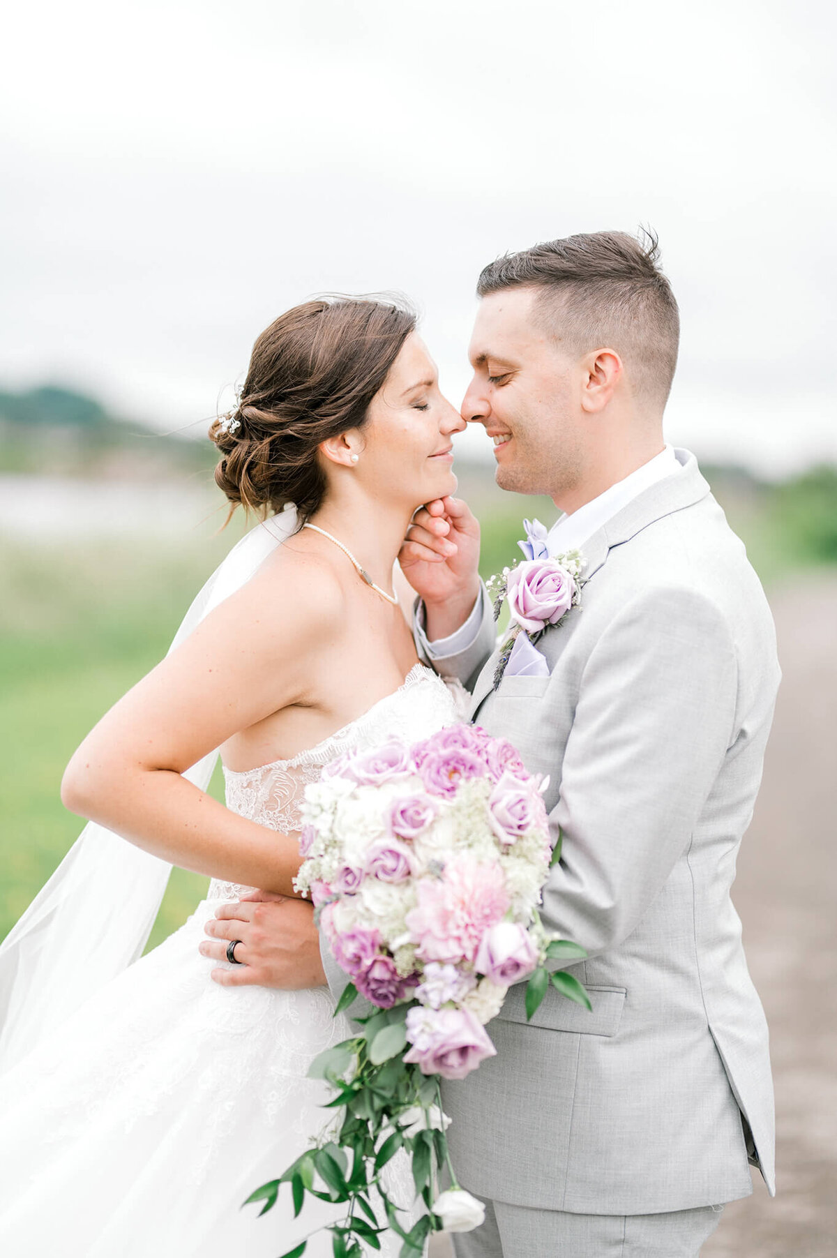 Bride and groom enjoy eskimo kiss and sweet smiles on wedding day