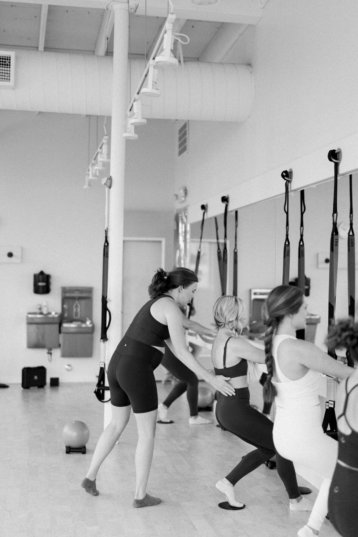 Fitness instructor teaching women in a workout class