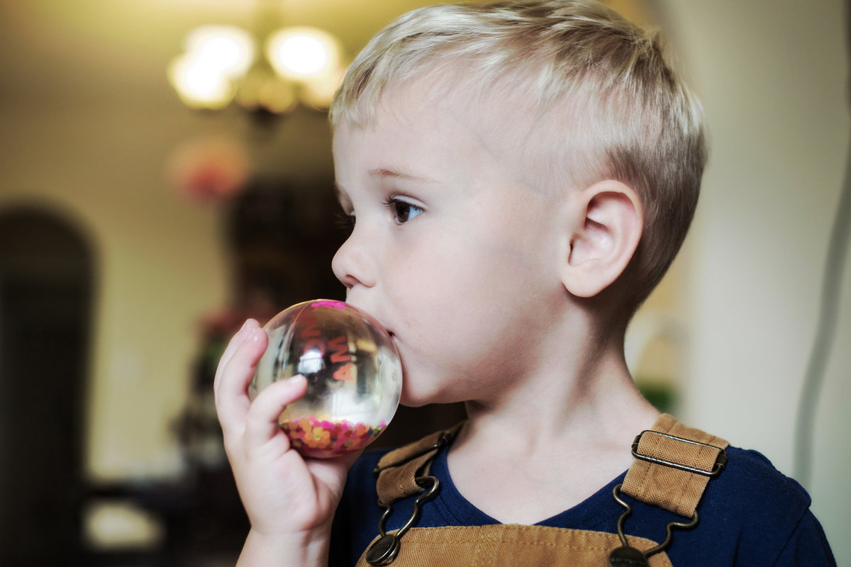 child with glass ball