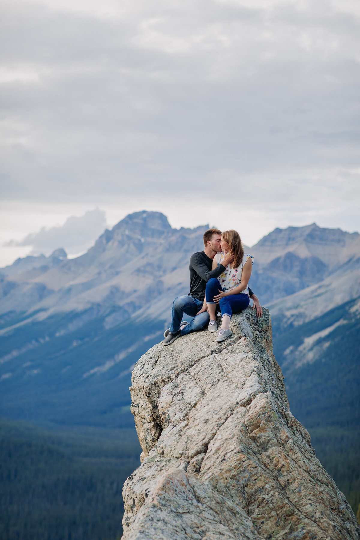 epic peyto lake engagement session high on rocks mountains in the distance