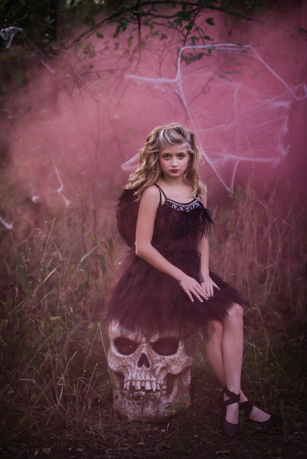 hirl-in-couture-sitting-on-skull-with-pink-smoke