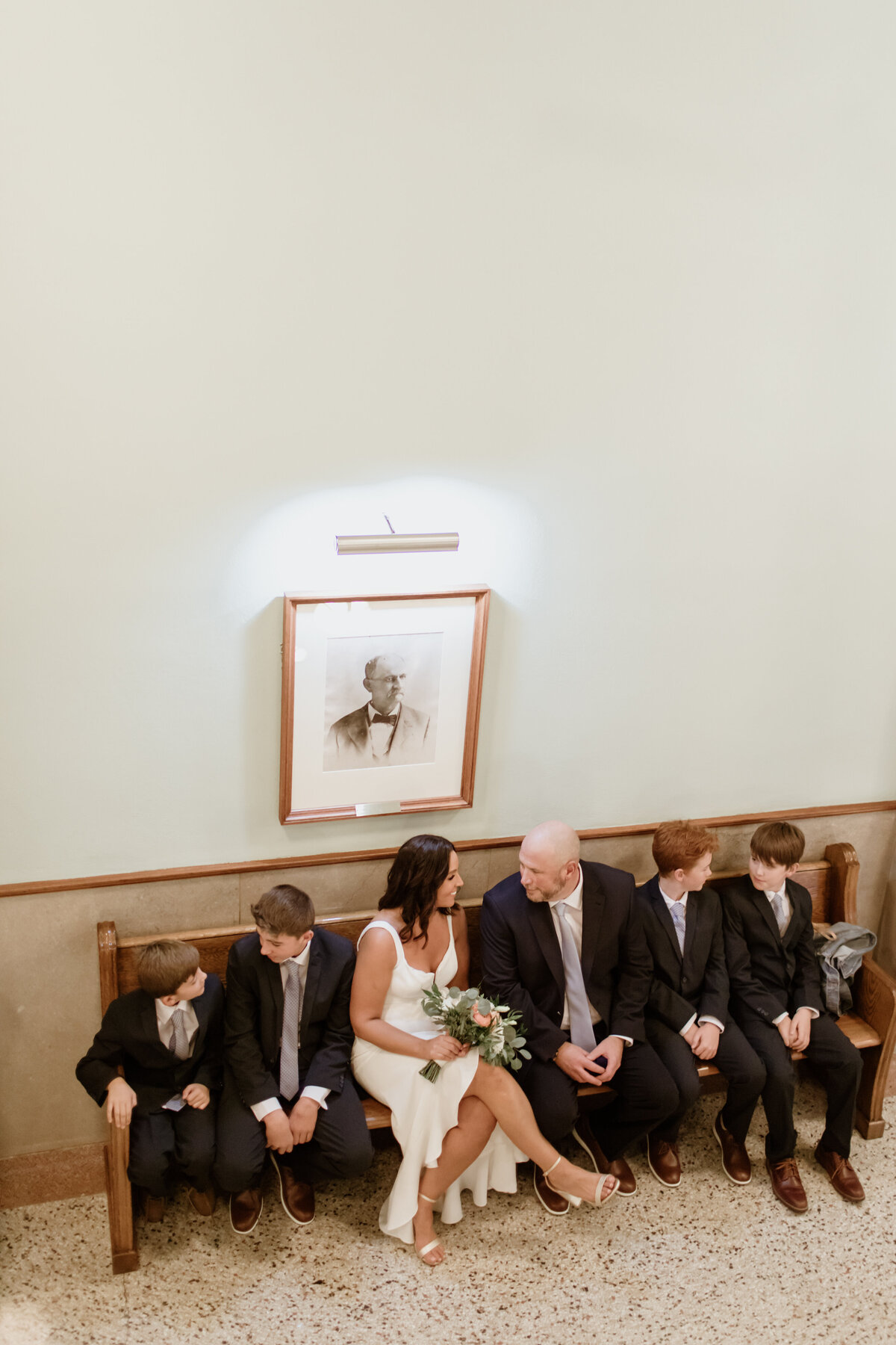 A bride and groom wait at the Tarrant County Courthouse for their intimate wedding captured by Fort Worth Wedding Photographer, Megan Christine Studio