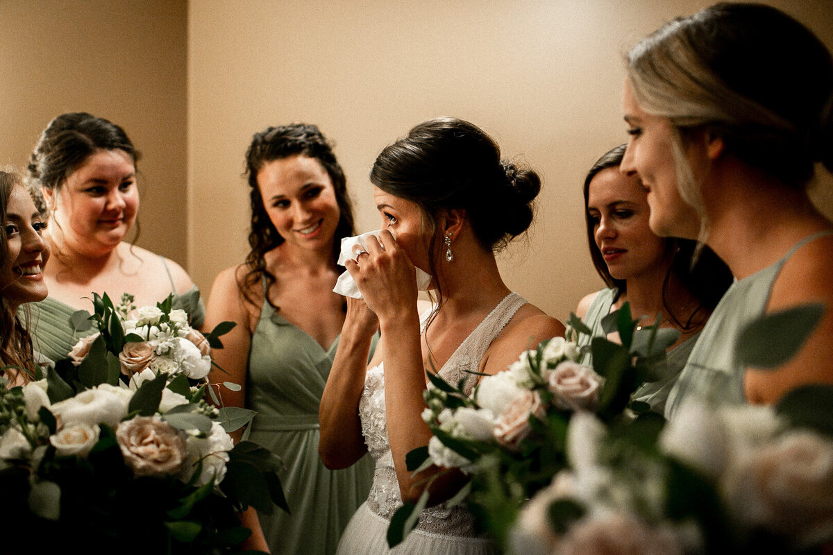 Iowa bridesmaids praying over bride