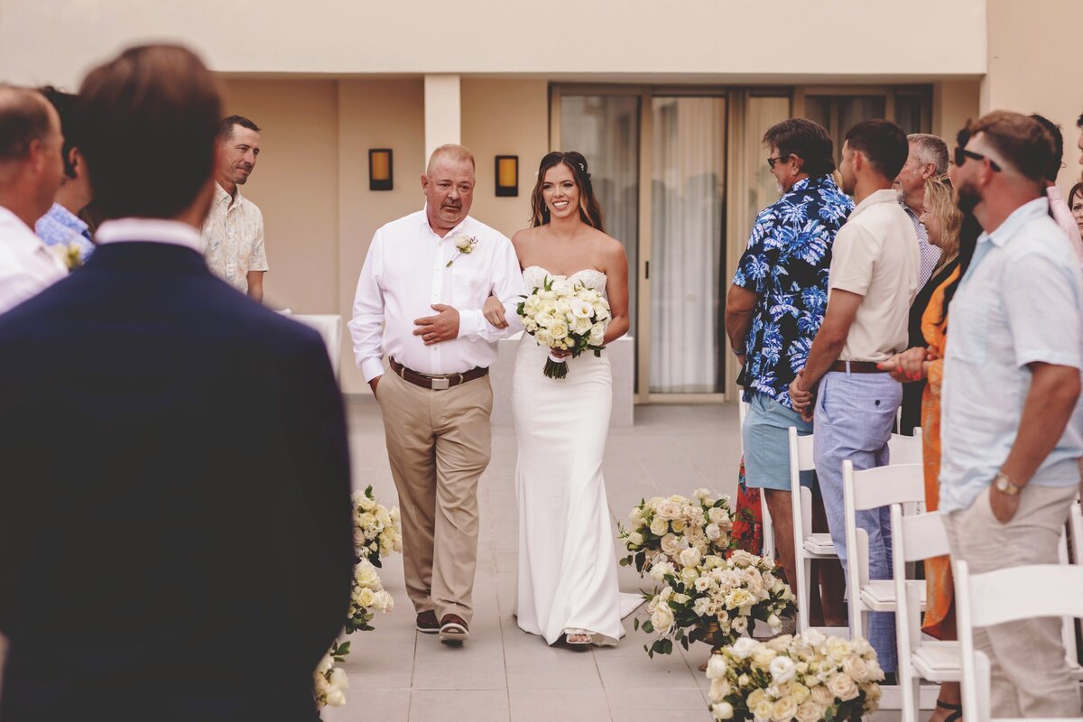 Bride walking down aisle with father at wedding in Cancun