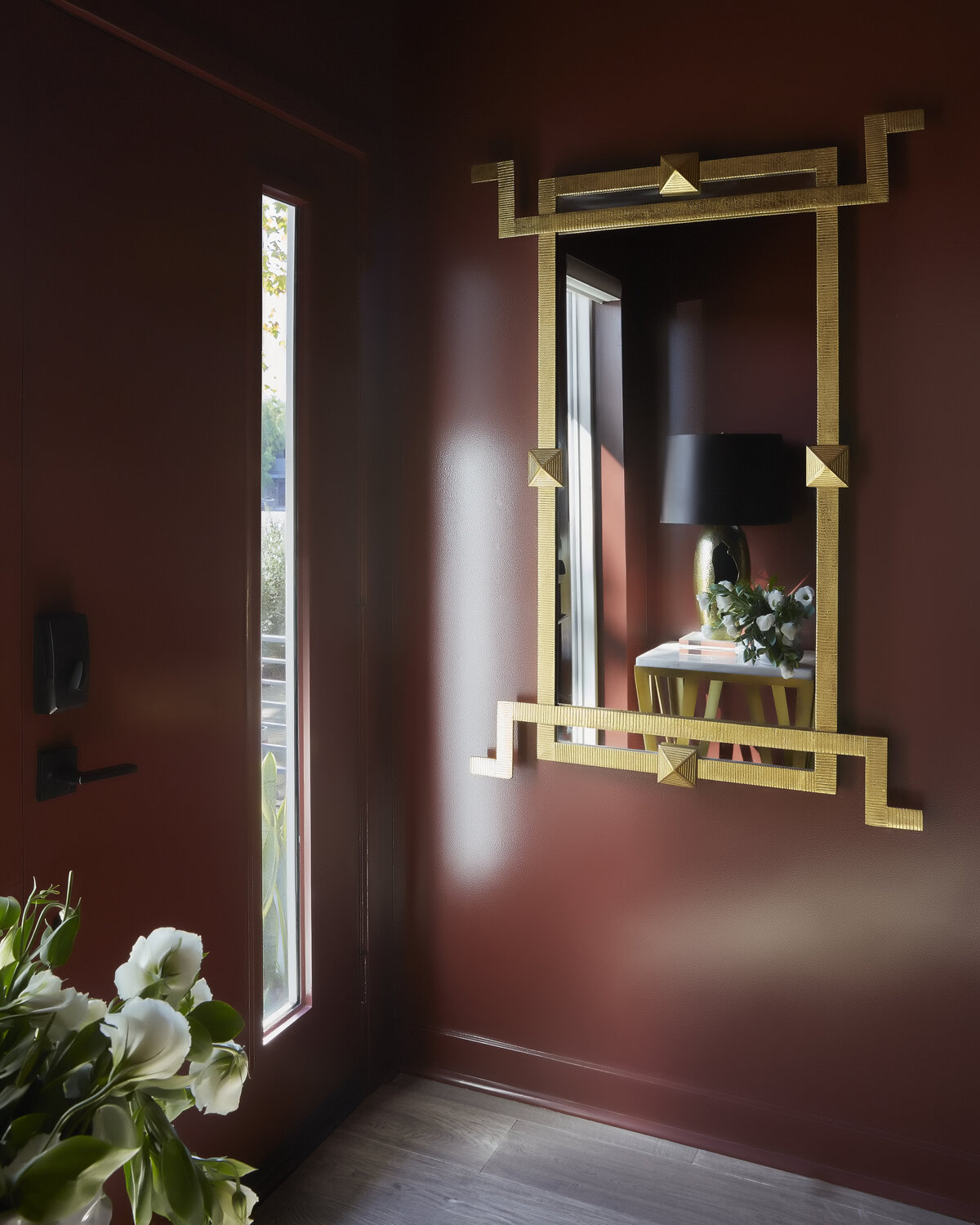 deep dark surface wall color with golden wall mirror