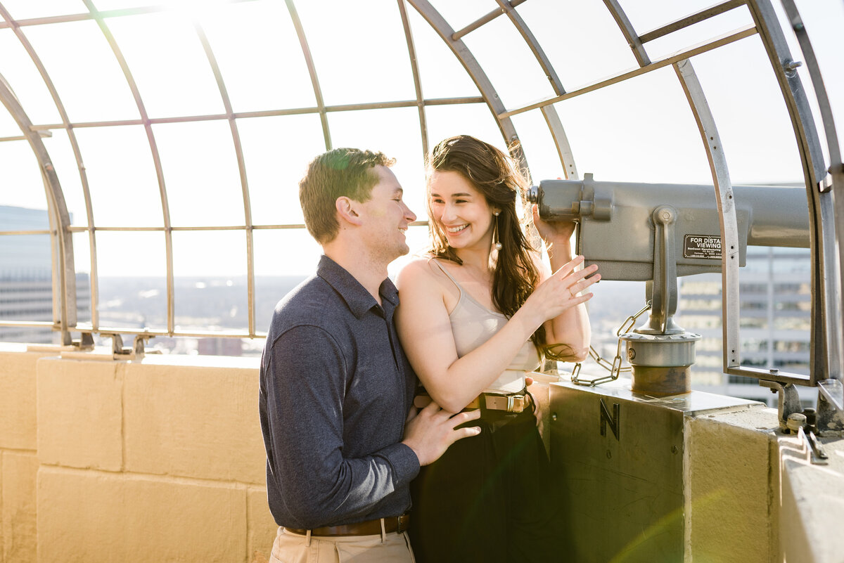 Couple smiling while looking at each other on the Foshay Tower Observation Deck