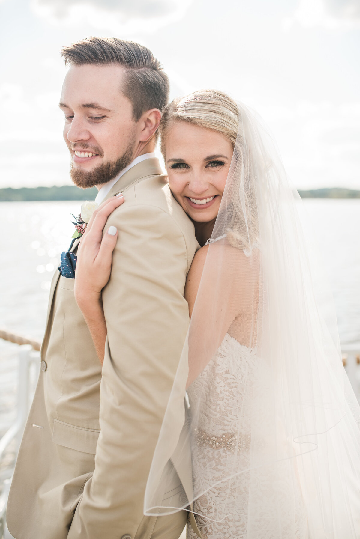 bride and groom portrait on water at waters edge event center maryland wedding venue