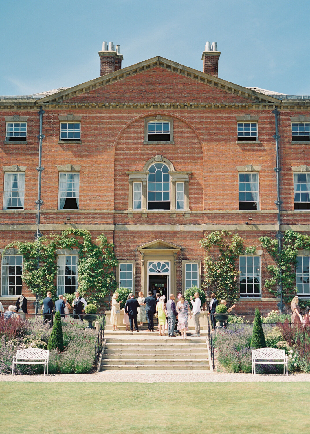 wedding guests enjoying drink reception hour in front of the Norwood park wedding venue in nottinghamshire