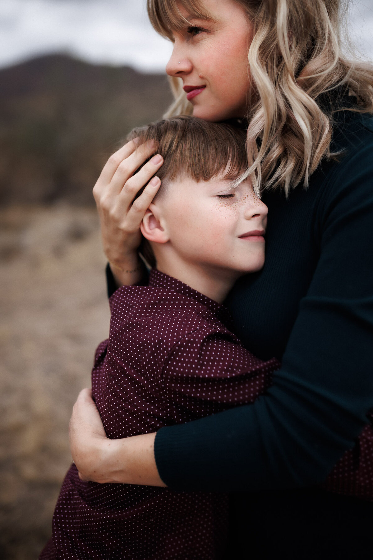 mom and son hugging with eyes closed