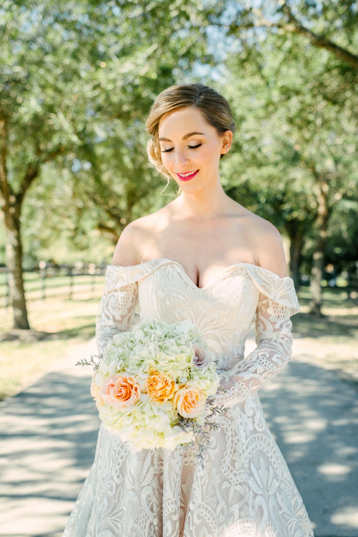 bride poses with bouquet
