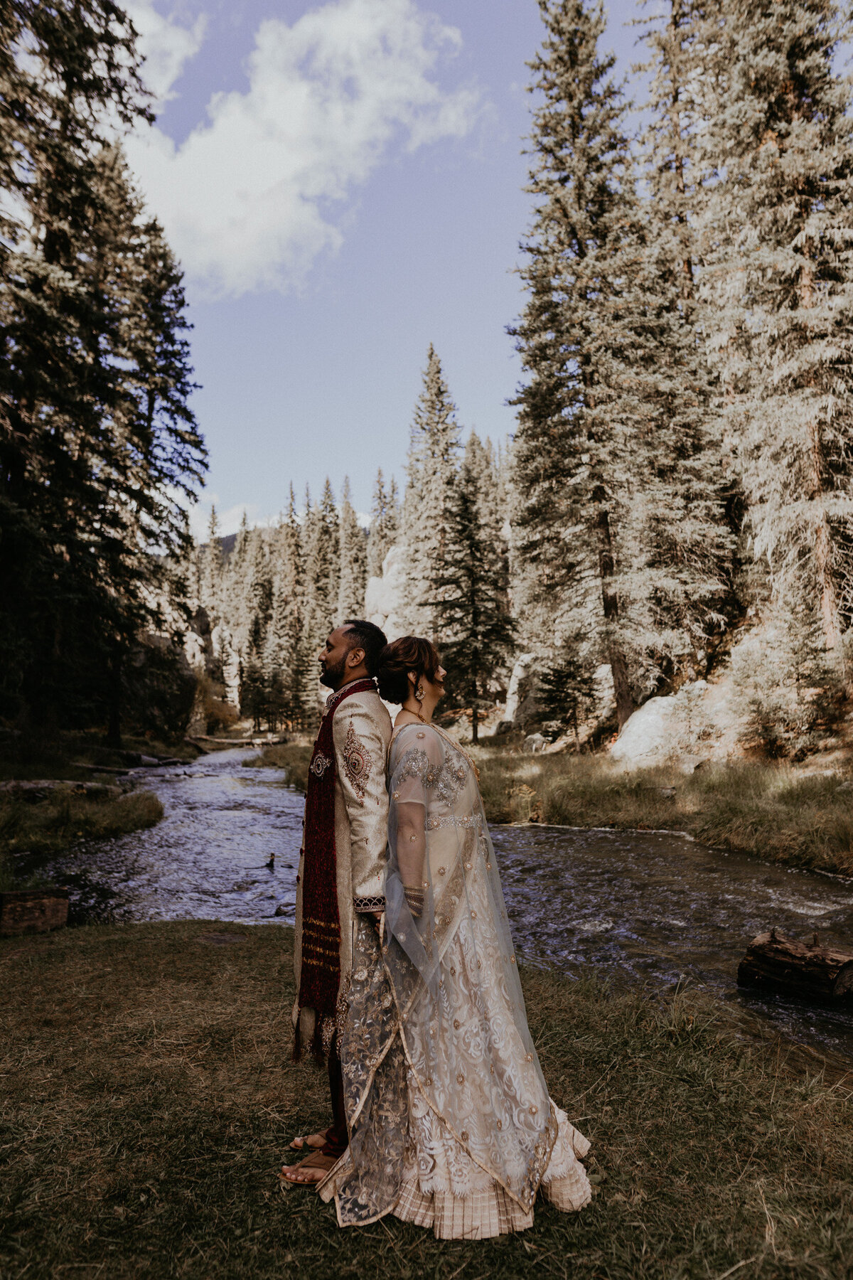 bride and groom walking along a creek in New Mexico