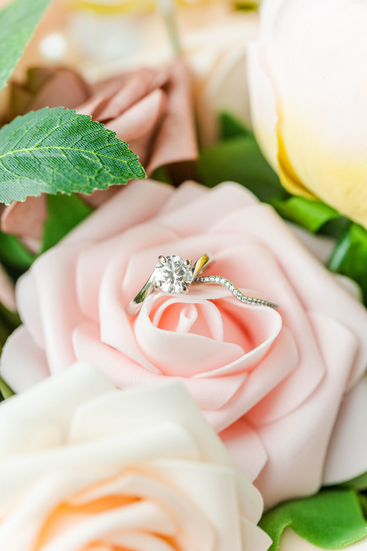 engagement and wedding rings in pink rose
