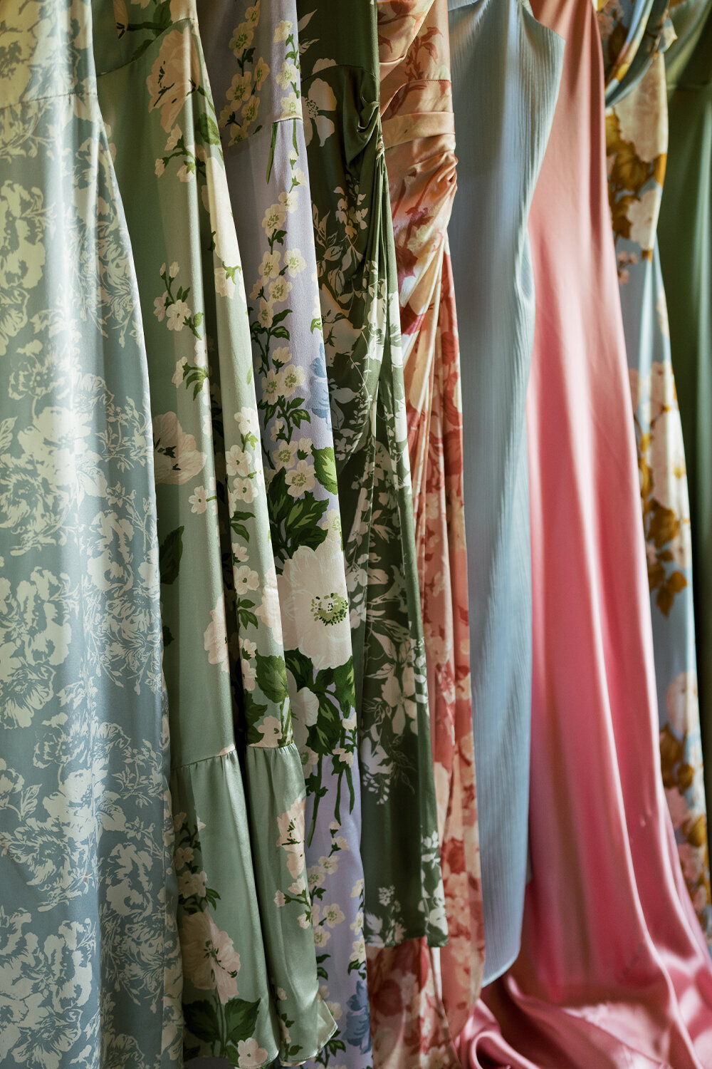 Bridesmaids dresses in various floral patterns and colors for a French blue-themed summer wedding in Jackson, Wyoming.