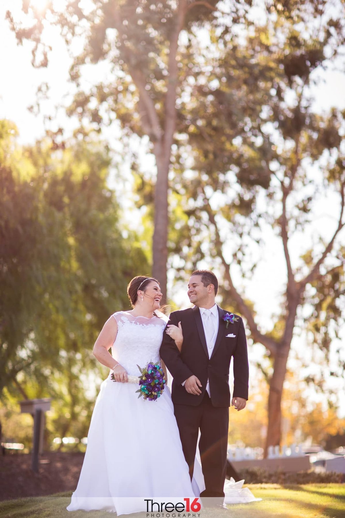 Bride and Groom cuddle up as they go for a walk along the golf course at Black Gold in Yorba Linda, CA