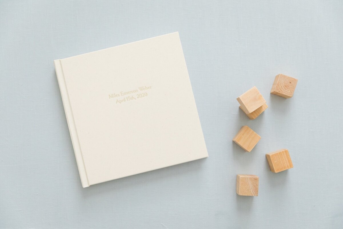 off white album with gold deboss on blue background