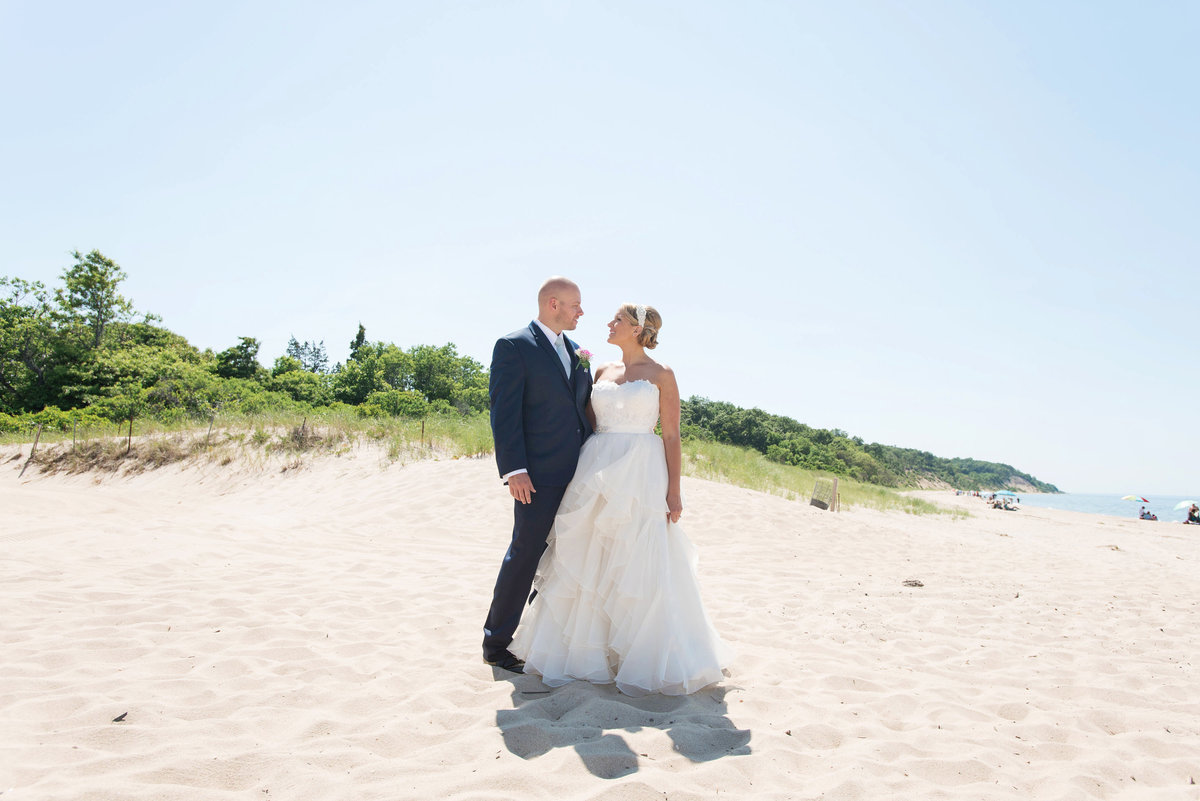 photo of bride and groom looking into each others eyes on the beach from wedding reception at Pavilion at Sunken Meadow