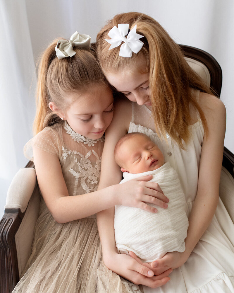 Newborn session of baby with two older sisters