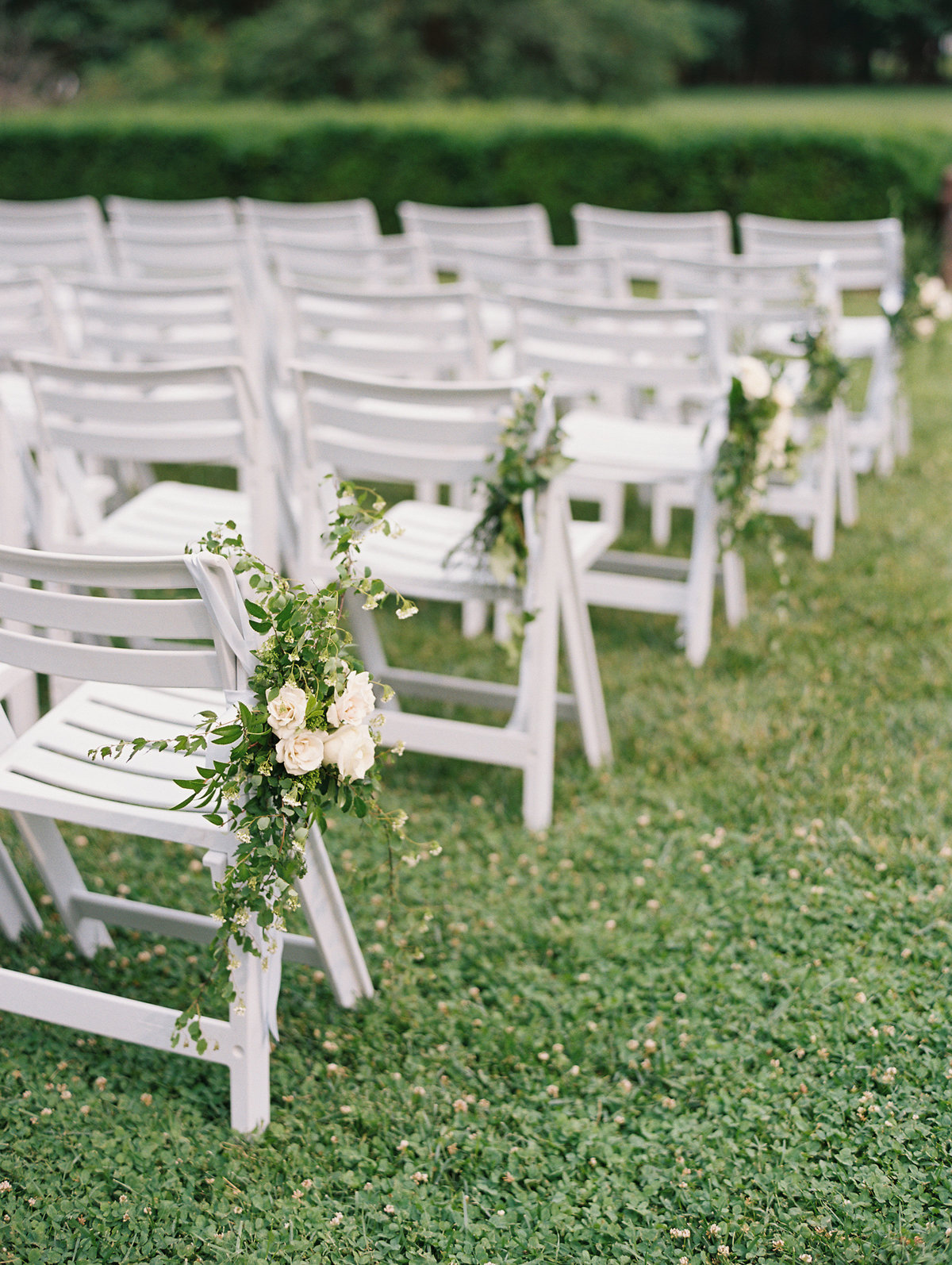 Floral décor with ceremony aisle chairs