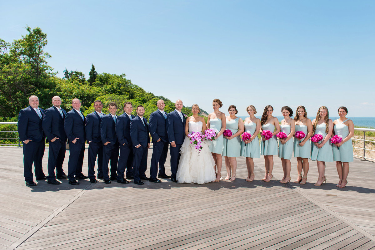 photo of bridal party with bride and groom on the boardwalk from wedding at Pavilion at Sunken Meadow