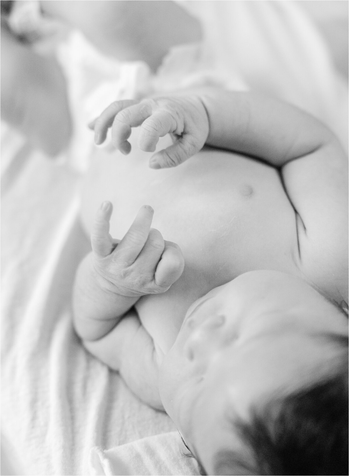 black and white image of newborn baby during fresh 48 session in indianapolis