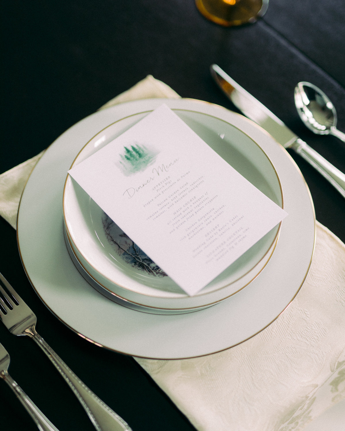 Close-Up of Elegant Gold-Trimmed China Plates and Menu at Venue3two