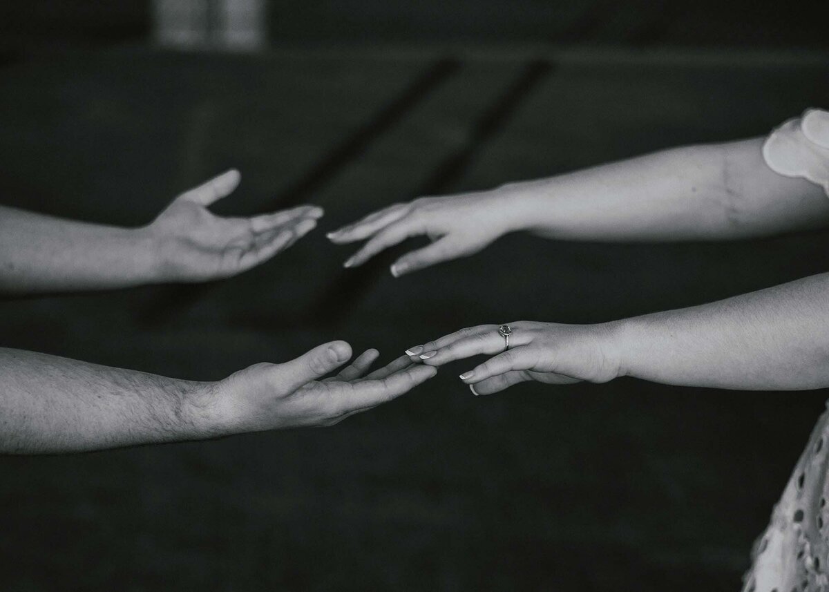 Maddie Rae Photography black and white of a couples hands pulling away from each other