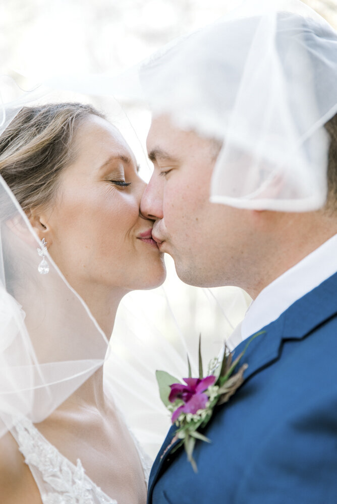 close shot of bride and groom kissing