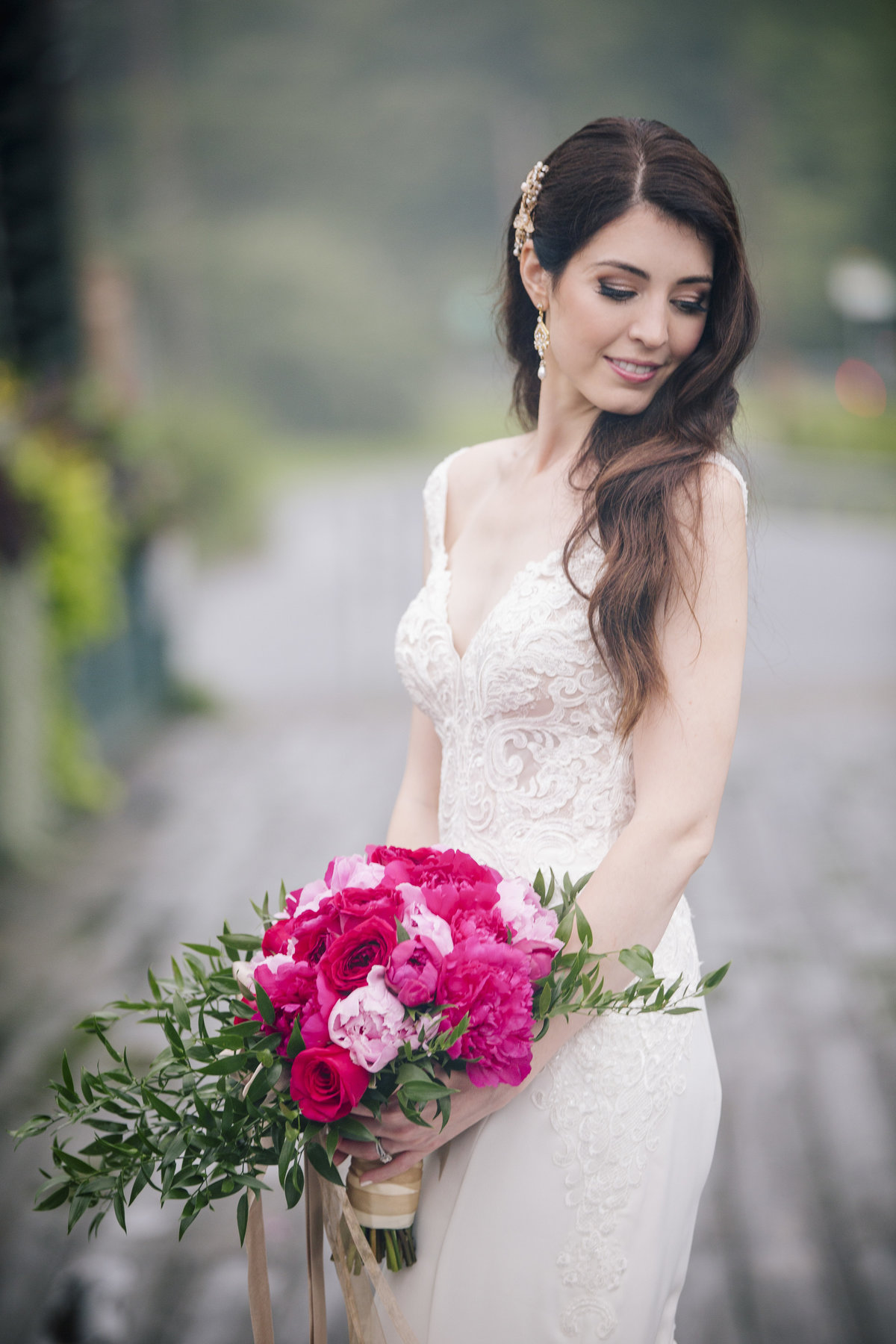 bride on bridge with flowers at riverview wedding