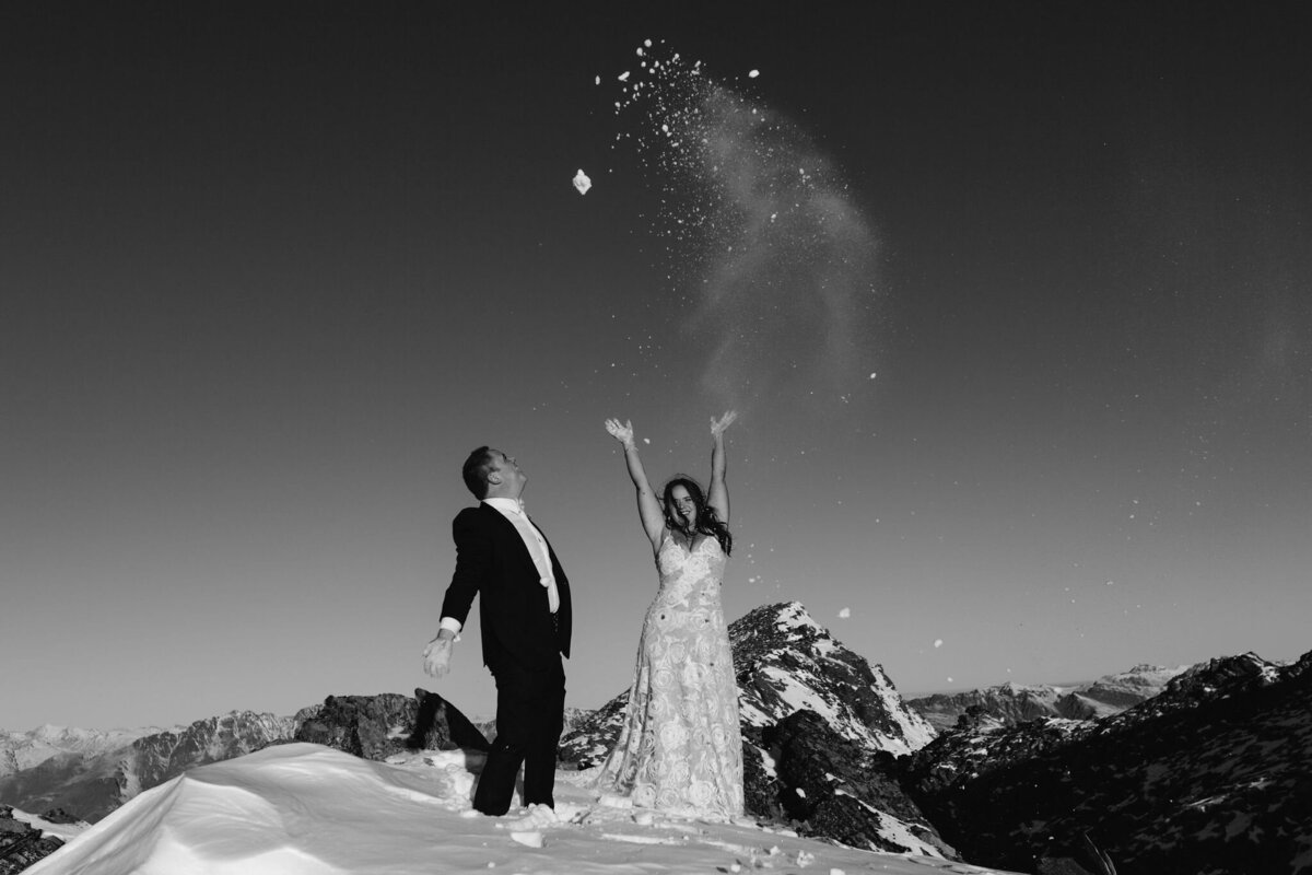 The Lovers Elopement Co - bride and groom on snow topped mountain - elopement with helicopter