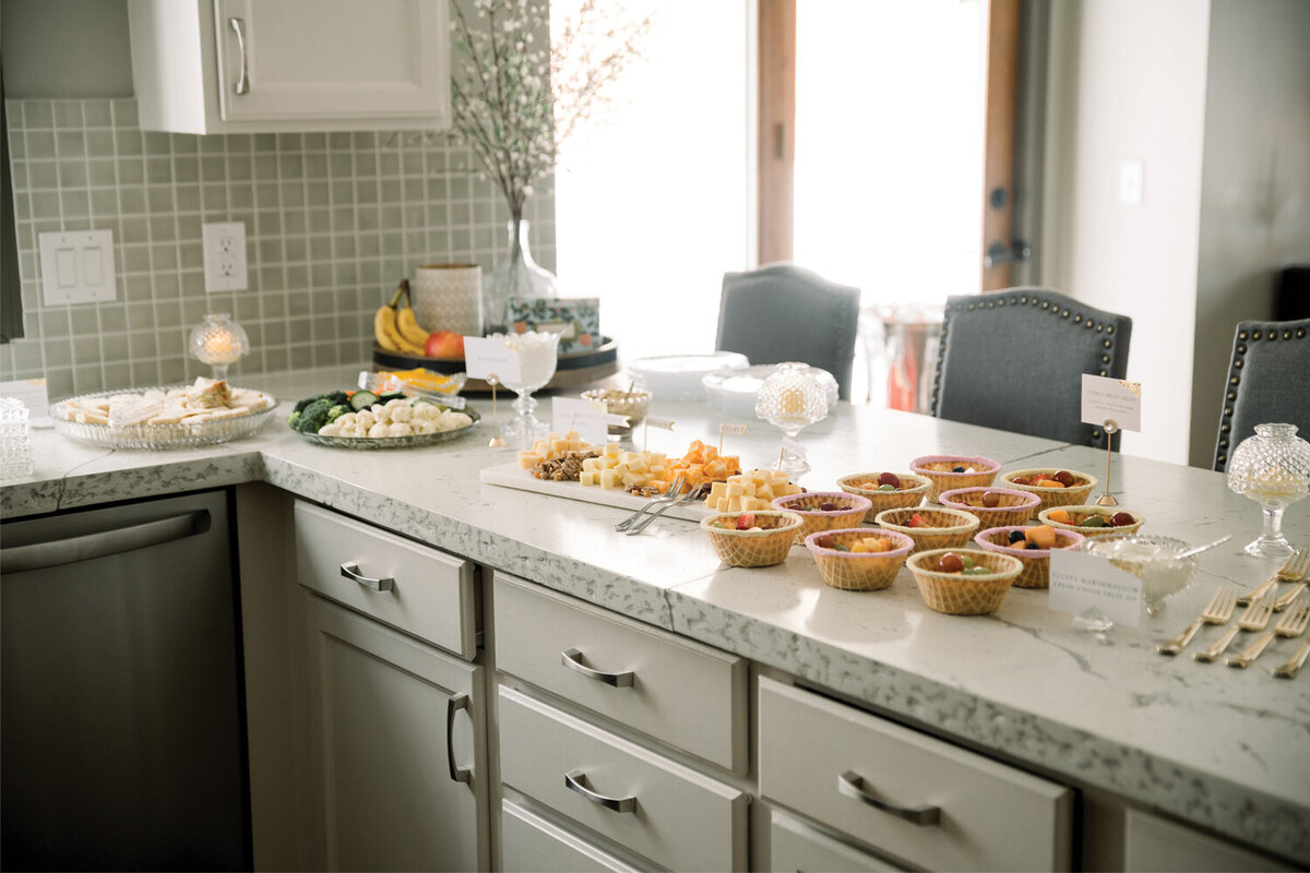 Charming food display for a pink and yellow girl baby shower, featuring beautifully arranged treats and decorations.