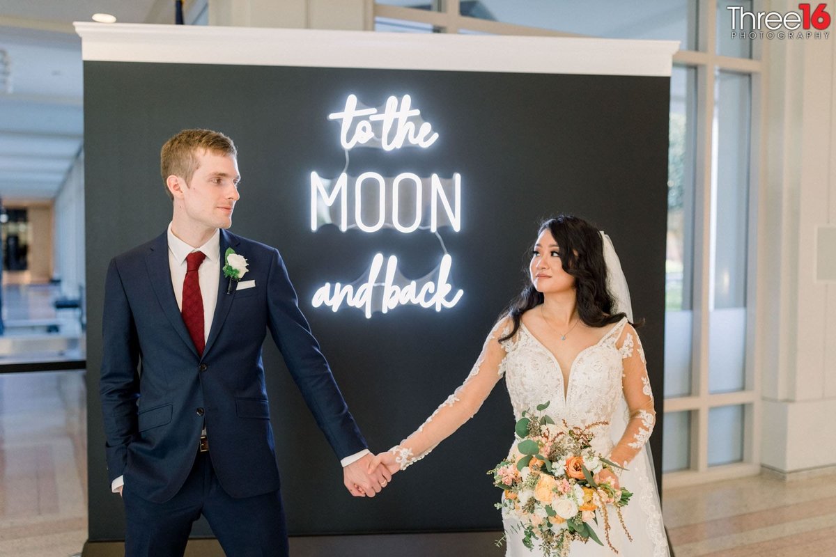 To the Moon and Back as the Bride and Groom pose for photos