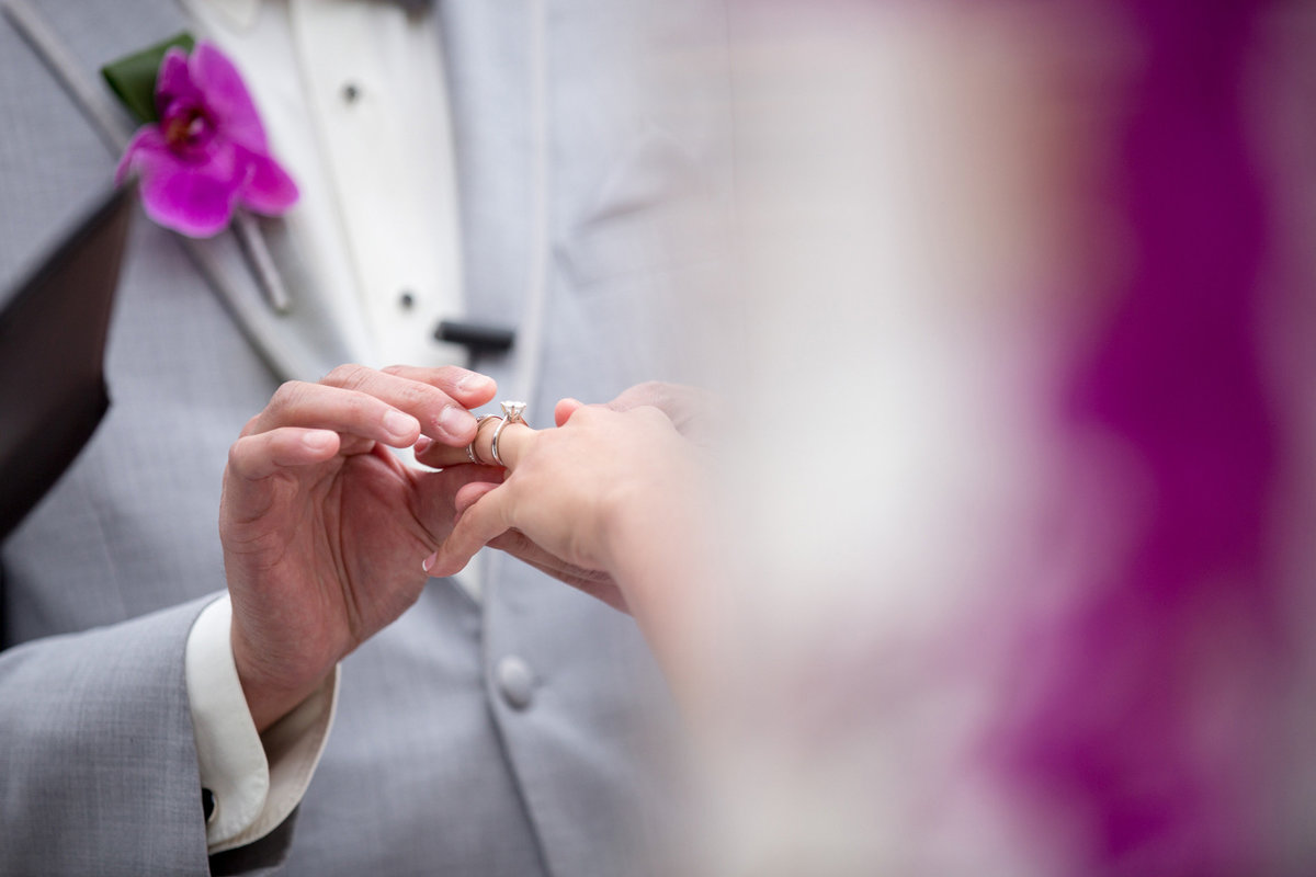 Ring exchange during a wedding ceremony at Bridgeview Yacht Club