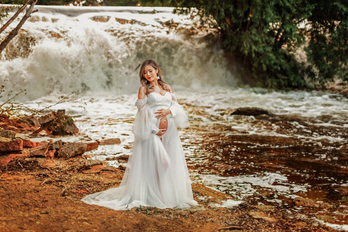Gorgeous maternity session in front of waterfall at Golden Pond park in Longmont.