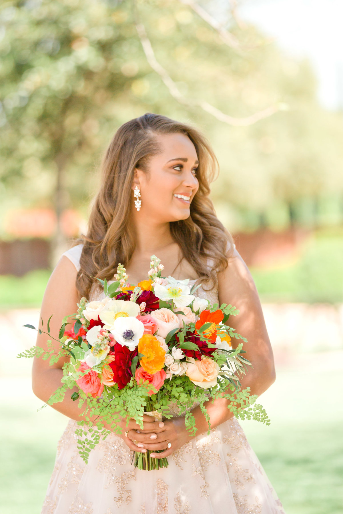 bridal portrait holding bridal bouquet of spring flowers