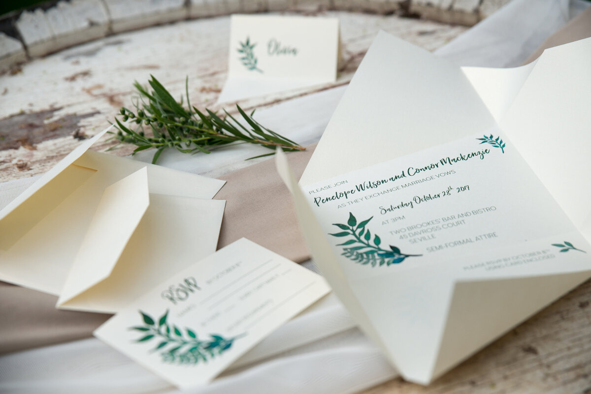 Greenery wedding invitation with folded design and matching envelopes