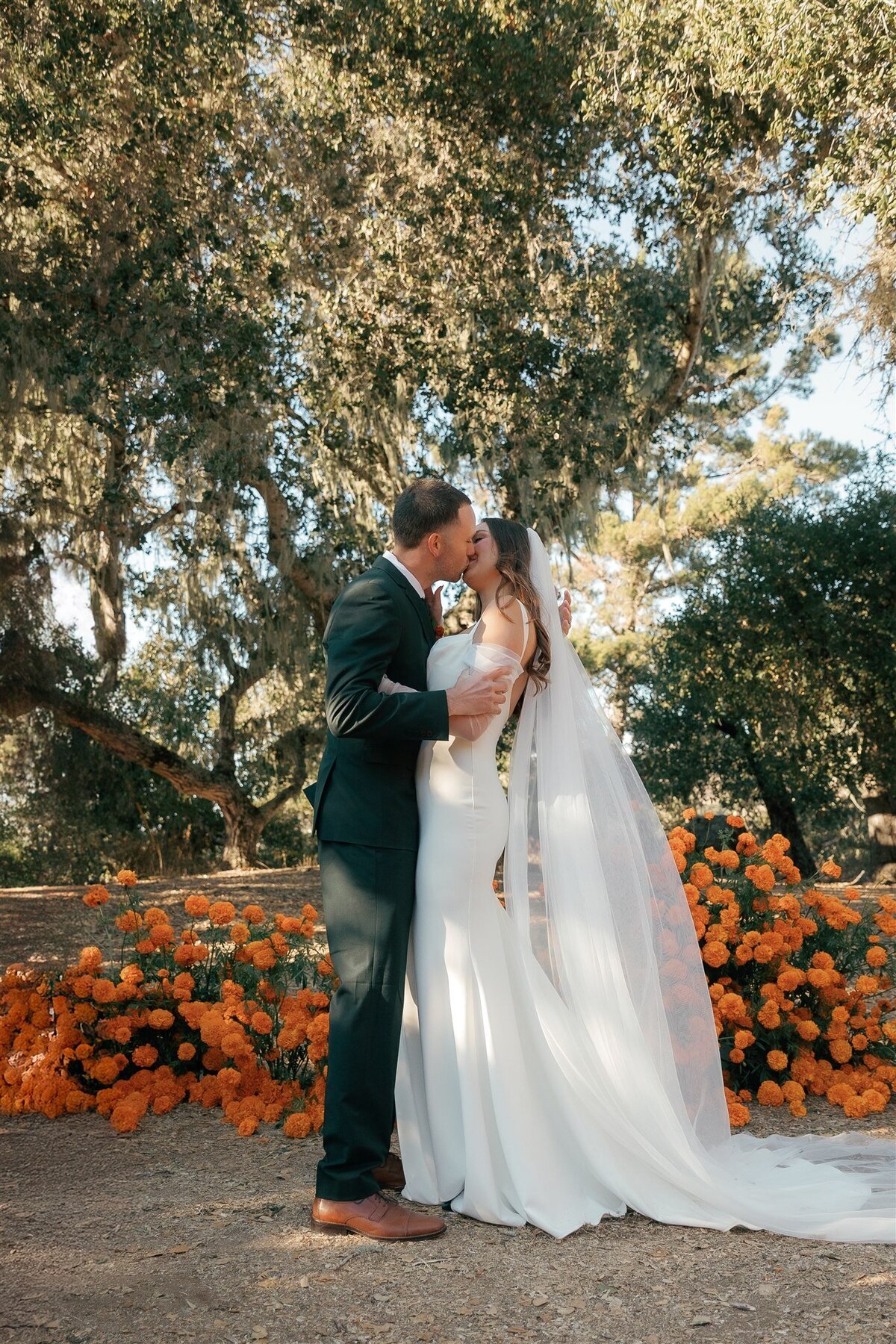 Carmel California wedding ceremony orange marigolds bride and groom
