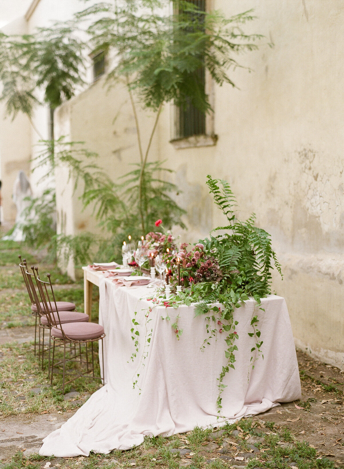 Nature-themed table decoration with white tablecloth.